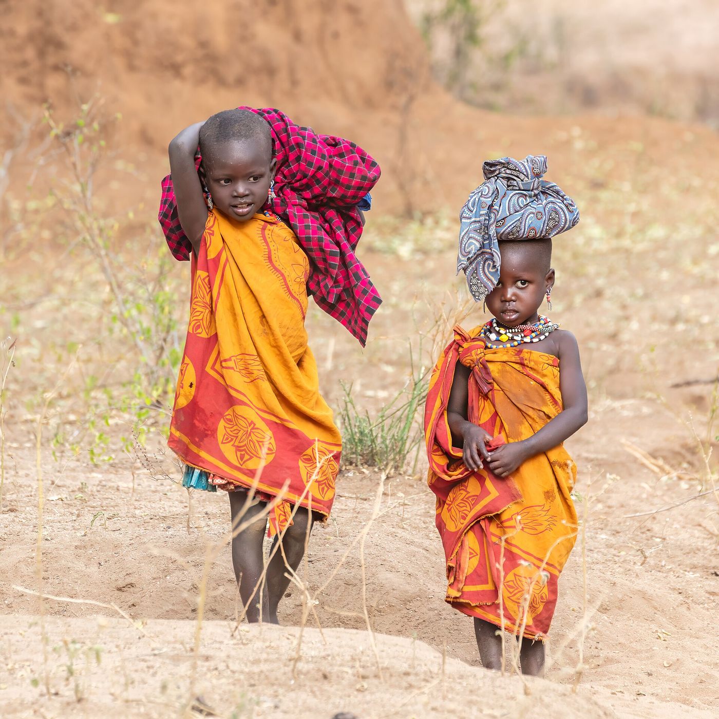 Two children of the Laarim community walking through their village