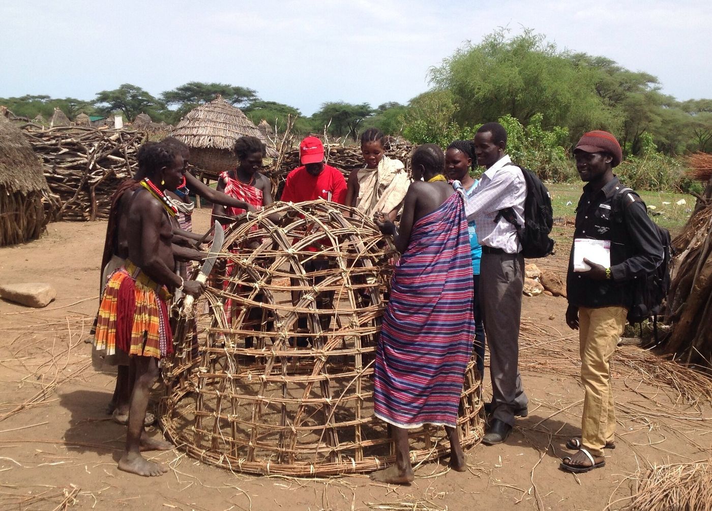 Women building a granary together in a village